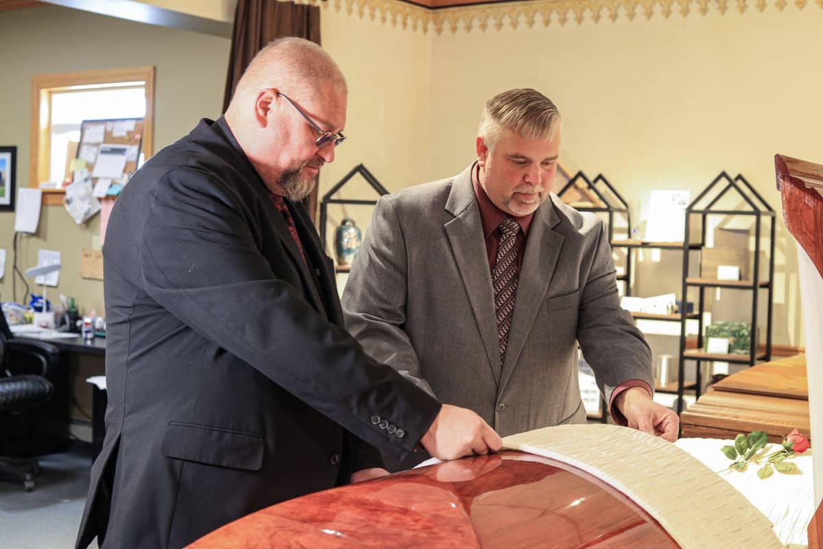 Two men preparing a casket