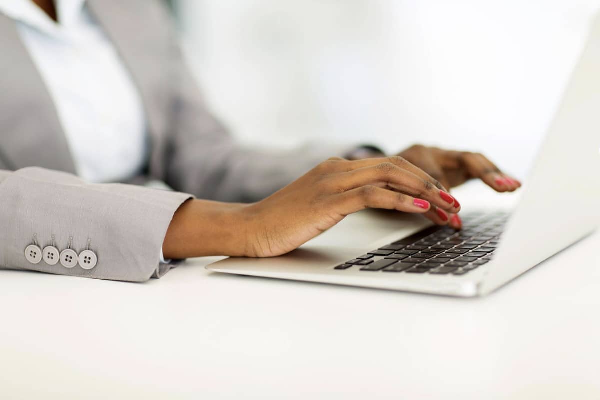 The hands of a woman on a laptop
