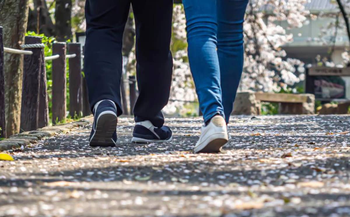 The feet of two people going on a walk