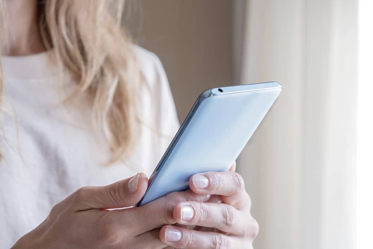 A woman holding a smartphone