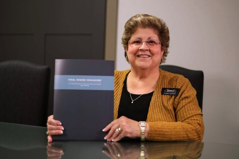 A woman at a desk with a folder that says "Final Wishes Organization"