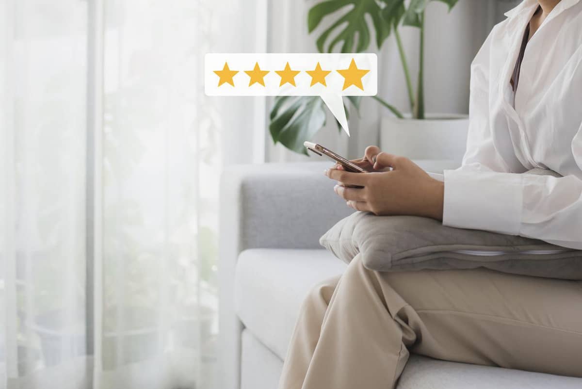 A phone showing 5 star review
