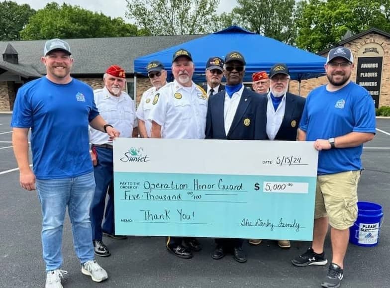 People from Sunset Funeral Homes with a check for Operation Honor Guard